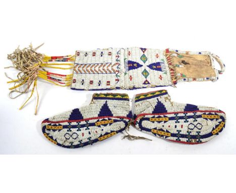 A Pair of North American Native Beaded Sole Moccasins, decorated with geometric bands and devices, possibly Western Sioux, ci