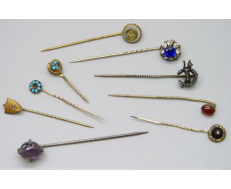 A collection of Victorian and later gilt stick pins and white metal examples 