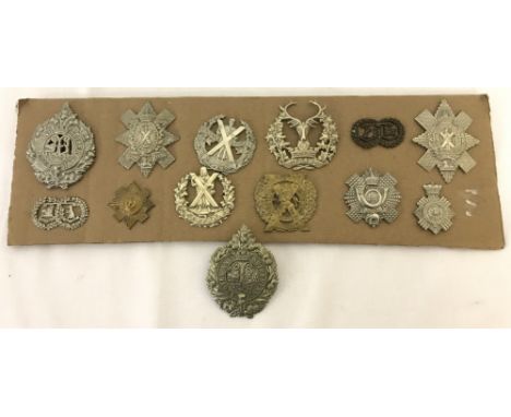 A collection of 13 original WWII era Scottish Regiments 2 lug cap badges.To include: London Scottish Queens Own Cameron Highl