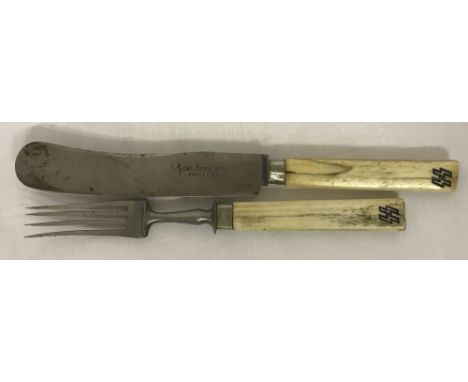 A WW2 Style bone handled knife and fork. Marked SS to handle.Some damage to the knife handle