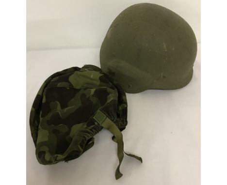 An Estonian army PASGT helmet.Complete with camouflage cover and canvas chin strap.Sold on behalf of a private collector.