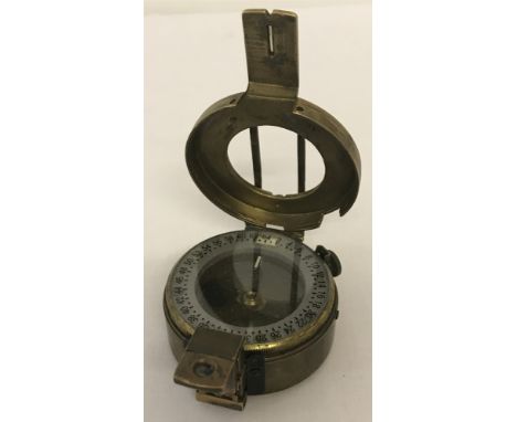 A vintage brass cased compass with hinged lid.Marked Stanley, London to base.Approx. 6cm diameter.
