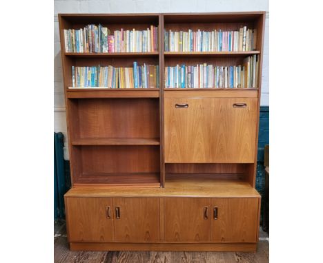 A G-Plan wall unit with a mirrored cocktail cabinet with glass shelf, and shelving over four doors. 198cm x 163cm x 46cm 