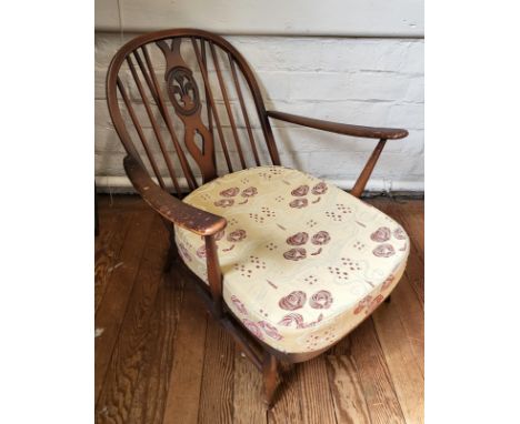 An Ercol Windsor armchair with cushion. 80cm x 70cm x 90cm 