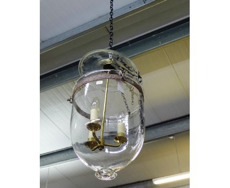 A glass domed light fitting containing a three branch fitting
