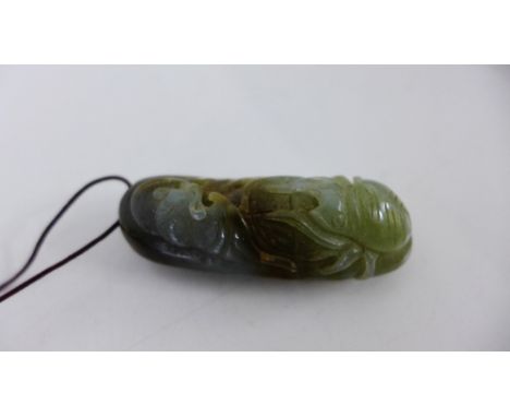 A carved jade pendant with insect and leaf pattern, 5.5cm long 