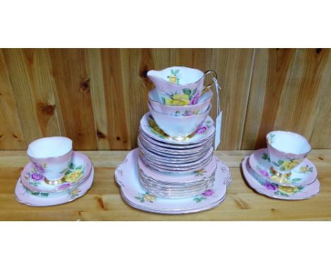 A Windsor bone china 'Rose' patterned teaset comprising twelve cups, twelve saucers, twelve side plates, two cake plates, two