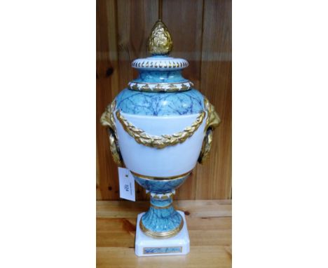 A Berlin porcelain urn and cover with gilt lion mask handles to side and acorn finial to top