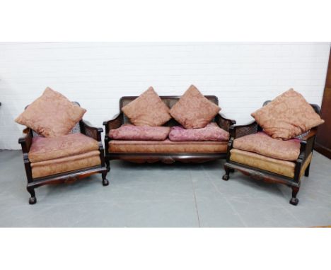 A three piece early 20th century mahogany framed Bergere lounge suite with pink upholstered seats and cushions, sofa 150 x 75