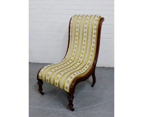 A mahogany framed upholstered bedroom chair on turned supports and ceramic castors, 92 x 50cm