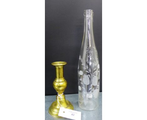 Eau de Vie etched glass bottle together with a knop stemmed brass candlestick, tallest 33cm (2) 
