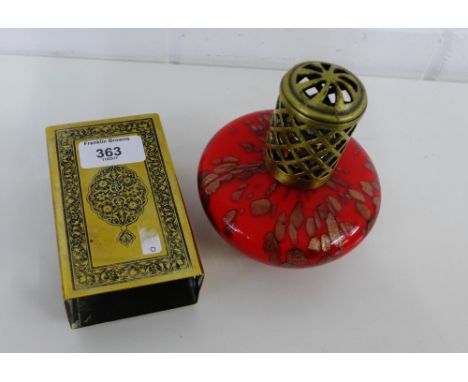 A brass engraved matchbox cover together with a red glass lamp (2) 