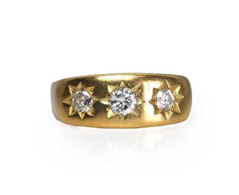 A diamond three stone gypsy ring,  with three graduated round brilliant cut diamonds, all star set to a plain mount, stamped 