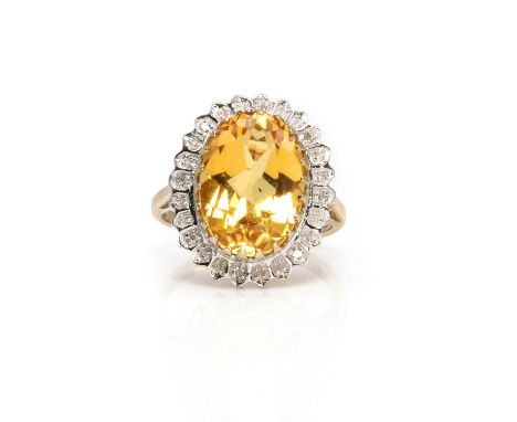 A 9ct gold citrine and diamond cluster ring,  the oval mixed cut citrine, 10.00 x 14.50mm, claw set to a 'pie crust' collet, 