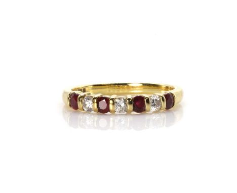 An 18ct gold ruby and diamond seven stone ring,  with round mixed cut rubies and round brilliant cut diamonds bar set to the 