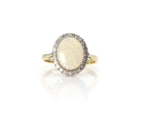 An 18ct gold opal and diamond cluster ring,  with an oval opal cabochon, 10mm x 12mm, to a surround of eight cut diamonds, al