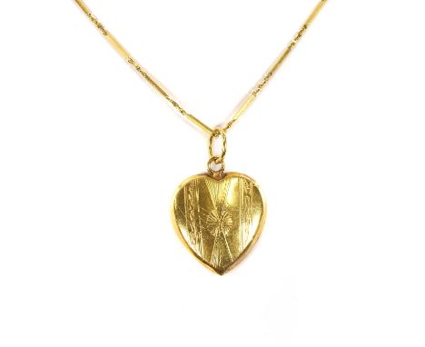 A heart shaped pendant and chain, the hollow heart shaped pendant engraved with the image of bird on one side and decorative 