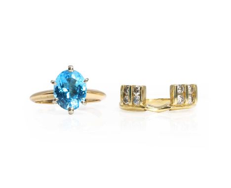 A single stone topaz ring and a fitted diamond set ring guard, a blue topaz ring,with an oval cut blue topaz, six claw set to