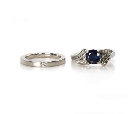 A platinum sapphire and diamond ring and a platinum band ring, a platinum, sapphire and diamond ring,with a round mixed cut s