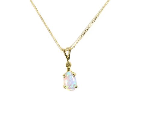 An opal and diamond pendant, with an oval opal cabochon, 6mm x 3mm, claw set to a small eight cut diamond, into a fixed split