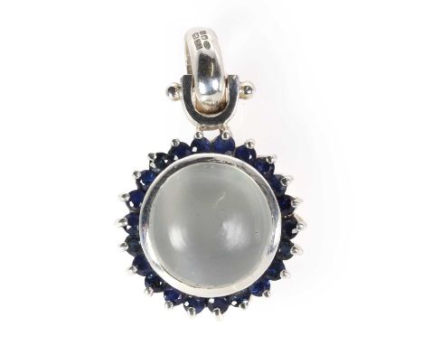 A silver moonstone and sapphire cluster pendant, with a central circular moonstone cabochon, bezel set to a surround of round