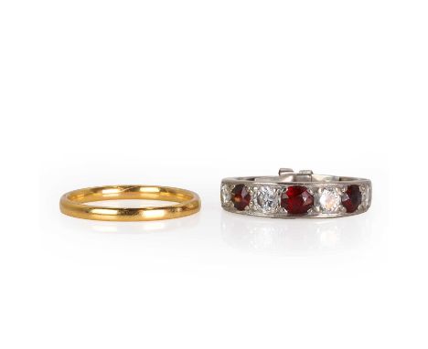 An 18ct white gold ruby and diamond ring and a gold wedding ring, with a line of alternating round cut rubies and round brill