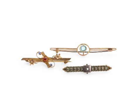 A group of three bar brooches, comprising an Edwardian 9ct gold brooch with stone set flowers to a flat bar with a scroll sur