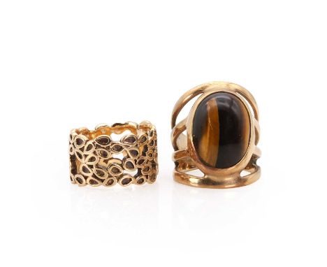 Two 9ct gold rings, a 9ct gold tiger's eye cabochon ring, with an oval tiger's eye, with pierced trifurcated shoulders and a 