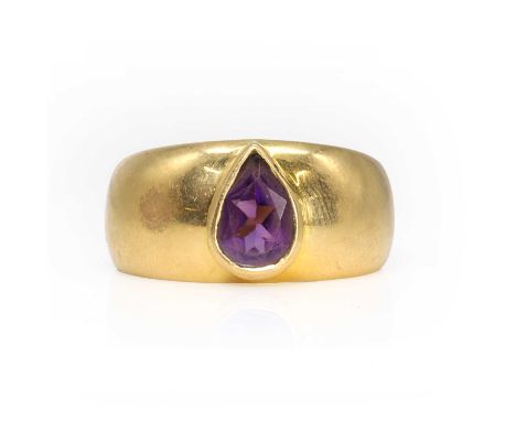 An amethyst single stone ring,  with a pear cut amethyst, approximately 9mm x 6mm, bezel set to a wide hollow domed band, wit