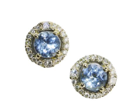 A pair of white gold aquamarine and diamond cluster stud earrings, each with a round cut aquamarine, 6mm in diameter, claw se