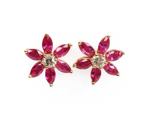 A pair of 18ct gold ruby and diamond cluster stud earrings, with a central round brilliant cut diamond, to a floral surround 