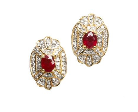 A pair of ruby and diamond cluster earrings, each with an oval mixed cut ruby claw set to the centre of a diamond set plaque,