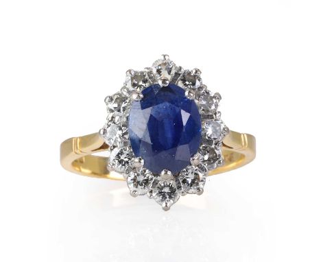 An 18ct gold sapphire and diamond cluster ring,  with an oval mixed cut sapphire, estimated as approximately 2.50ct, encircle