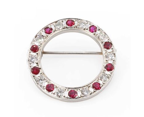 A 9ct white gold ruby and diamond circle brooch, with round cut rubies alternating to round brilliant cut diamonds, all grain