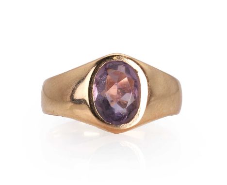 An amethyst single stone ring,  with an oval cut amethyst, bezel set to a plain tapering hoop, tested as approximately 14ct g