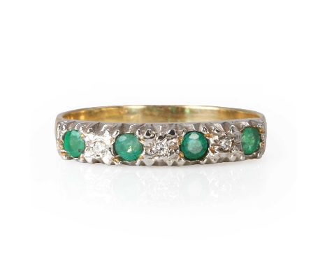 A emerald and diamond seven stone ring,  with round cut emeralds, alternating to smaller brilliant cut diamonds, all spitch s