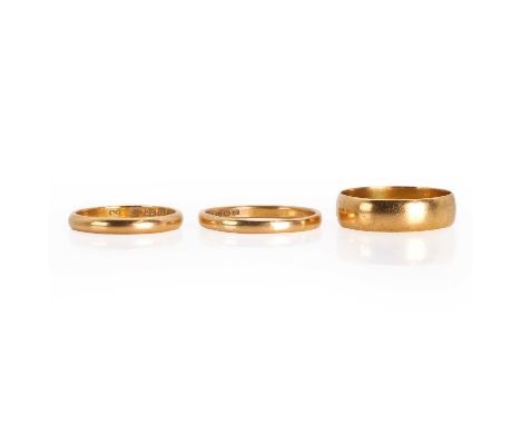 A group of 22ct gold wedding bands, a 22ct gold flat profile wedding ring, Birmingham 1917, a 22ct gold court profile wedding