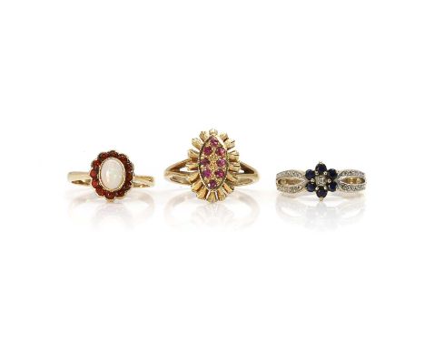 A group of three 9ct gold dress rings, a 9ct gold ruby navette ring, London 1971, a 9ct gold sapphire and diamond daisy clust