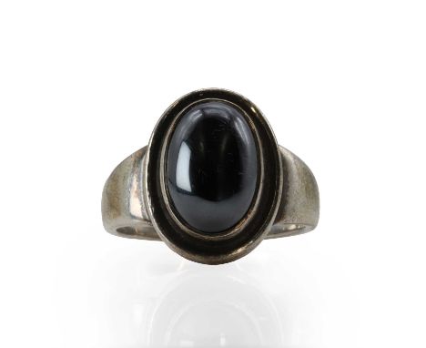 A sterling silver and haematite ring, by Georg Jensen,  no. 46B, with an oval haematite cabochon rub set to a plain mount. Ma