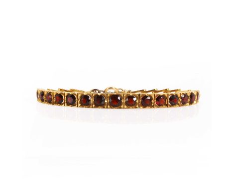 A garnet set line bracelet, the front section composed of graduated circular mixed cut garnets in articulated square settings