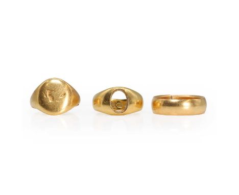 A group of three gold rings, an 18ct gold signet ring,gemstone vacant, London 1888,a signet ringshank cut, tested as approxim