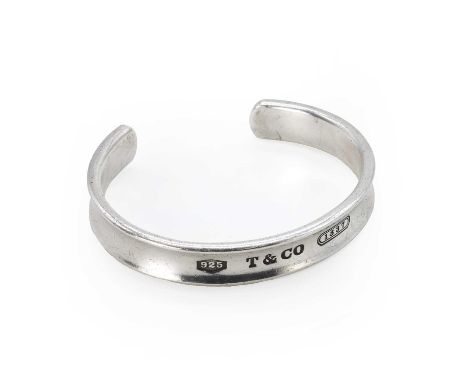 A silver bangle, by Tiffany & Co., a concave oval open bangle with the outside stamped '925 T &amp; Co. 1837', internal stamp