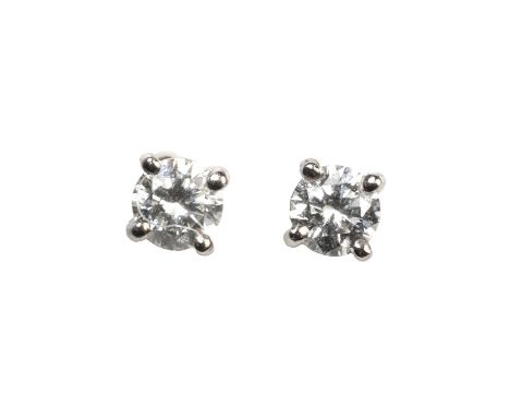 A pair of platinum single stone diamond stud earrings, each with a round brilliant cut diamond, the combined weight estimated