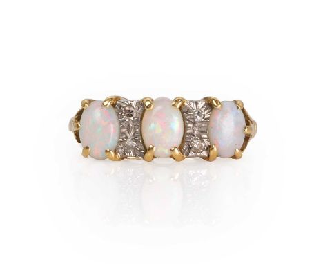 An 18ct gold opal and diamond three stone ring,  the three oval cabochon opals interspaced with small single cut diamonds, cl