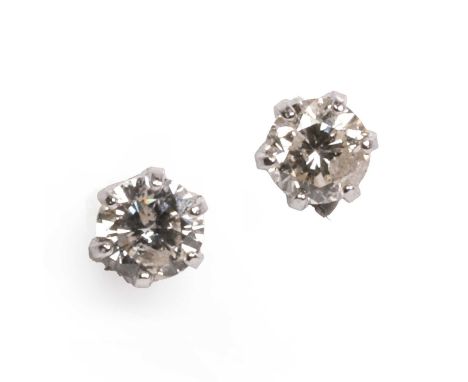 A pair of 18ct white gold diamond stud earrings, a round brilliant cut diamond, six claw set to post fittings and silicone bu