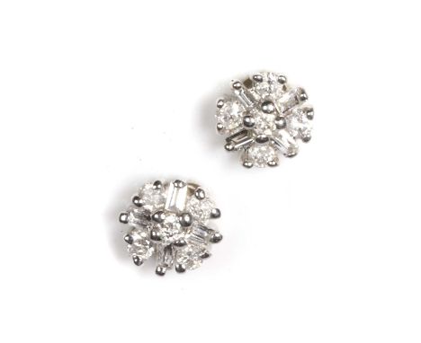 A pair of white gold diamond cluster stud earrings, each cluster with round brilliant cut diamonds and baguette cut diamonds,