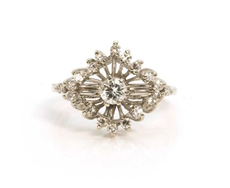 A mid-20th century diamond dress ring,  with a round brilliant cut diamond in a claw setting, within a lozenge shaped surroun