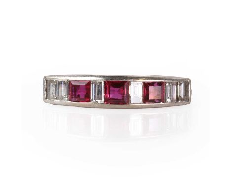 A white gold ruby and diamond ring,  with a line of alternating square cut rubies and baguette cut diamonds, all channel set 