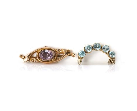 An Edwardian amethyst brooch and a blue zircon crescent brooch, an Edwardian amethyst scrolling bar brooch, an oval amethyst,