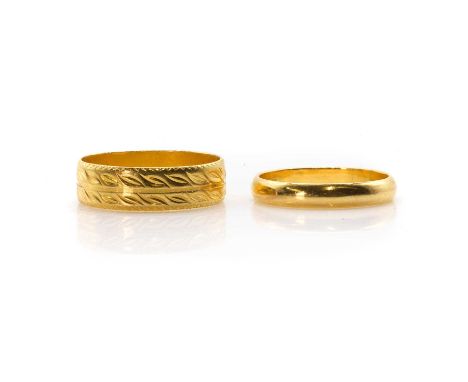 Two gold wedding rings, an engraved wedding ring, with engraved foliate rows, to a flat profile band, stamped 916, tested as 